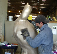 Artist working on sculpture.