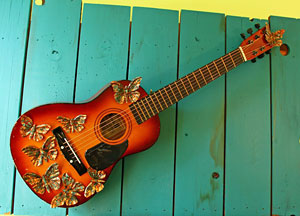 Guitar with copper butterfly sculptures
