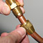 Hand tightening a fitting on a copper tube